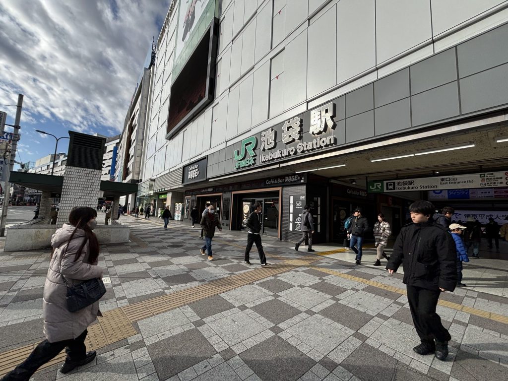 Entrance and pedestrians outside Ikebukuro Station in Tokyo